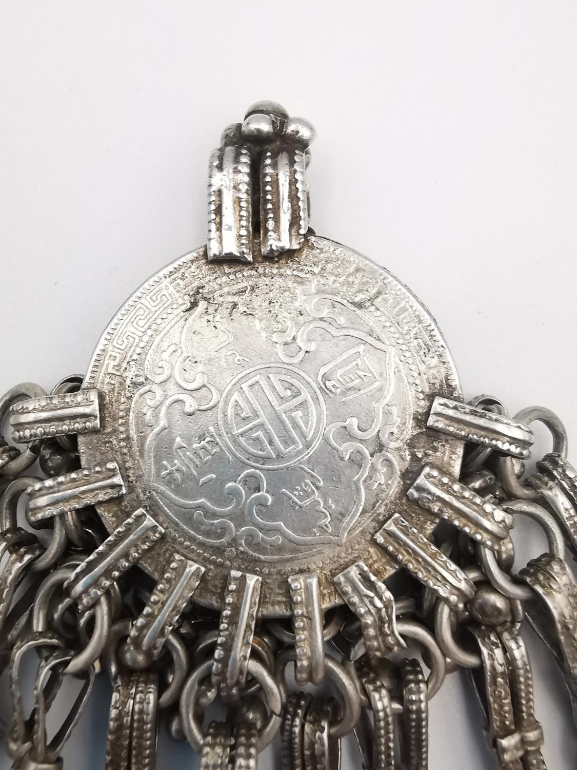 An early 20th century white metal Chinese silver Trade Dollar Omani pendant. The central coin with a - Image 5 of 5