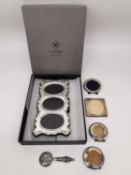 A collection of sterling silver frames and a mirror, including a boxed Carrs silver three picture