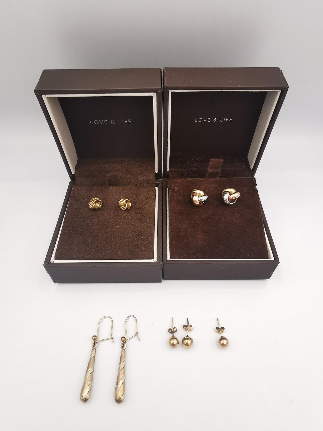 Four pairs of 9ct gold stud and drop earrings and one single ball earring, two boxed. Two pairs of