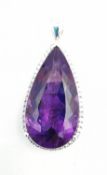 A contemporary 18ct white gold amethyst and diamond statement drop pendant. The pendant set with a