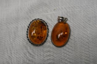 A silver and amber brooch and pendant. Size is H.4 W.2 D.1