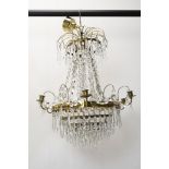 A Swedish Lead Crystal basket chandelier with gilt metal frame and crystal swags and drops.