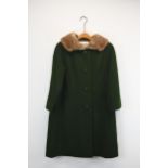 A vintage Harrod's army green women's winter coat with a mink fur collar. Label to interior.