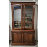 A 19th century style mahogany library bookcase, in two sections. H.223 W.130 D.60