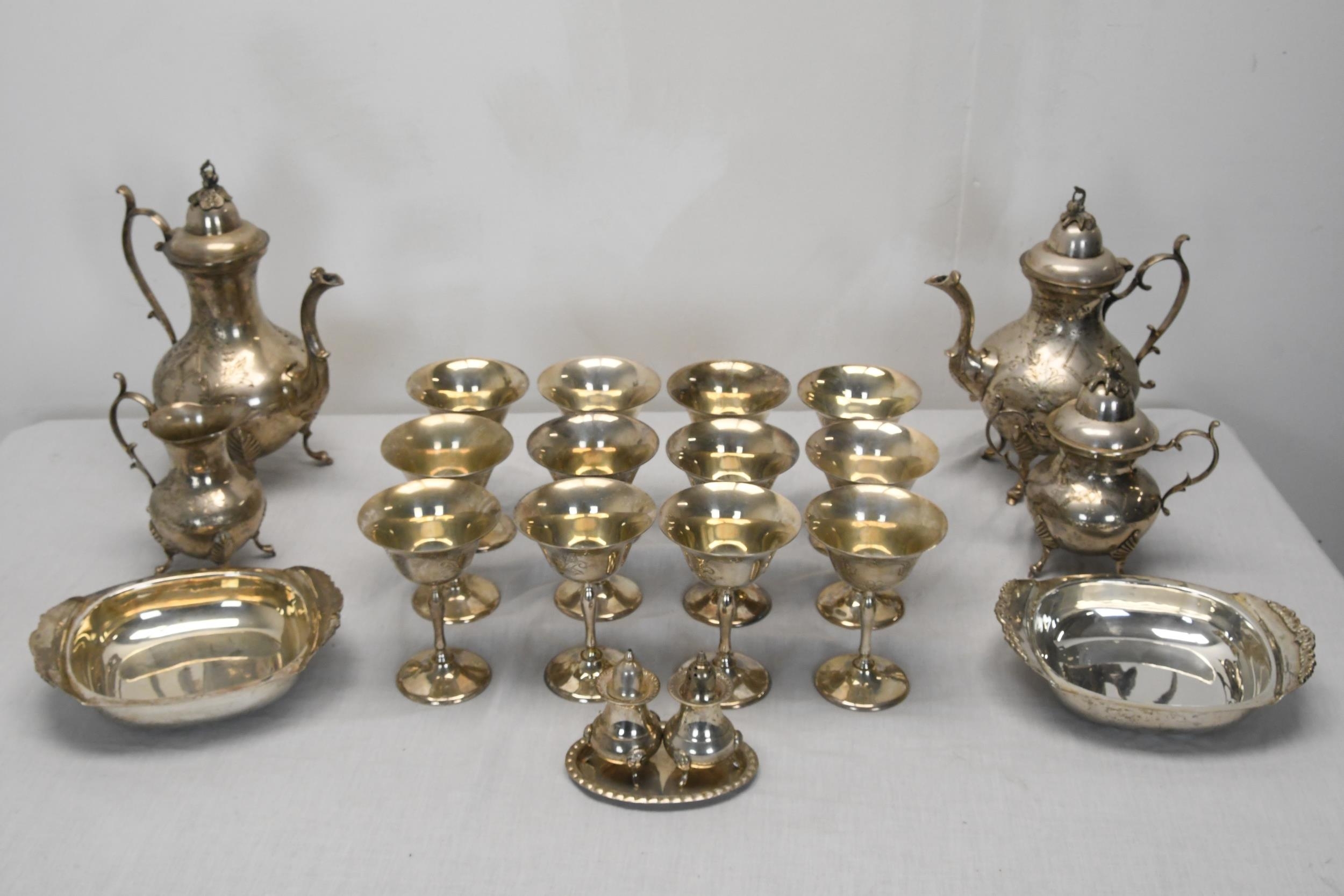A collection of silver plated items, including an engraved silver plate three piece coffee set, a