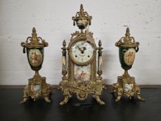 A Franz Hermle 3 piece ceramic and brass garniture clock, with key
