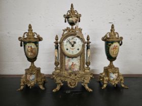 A Franz Hermle 3 piece ceramic and brass garniture clock, with key