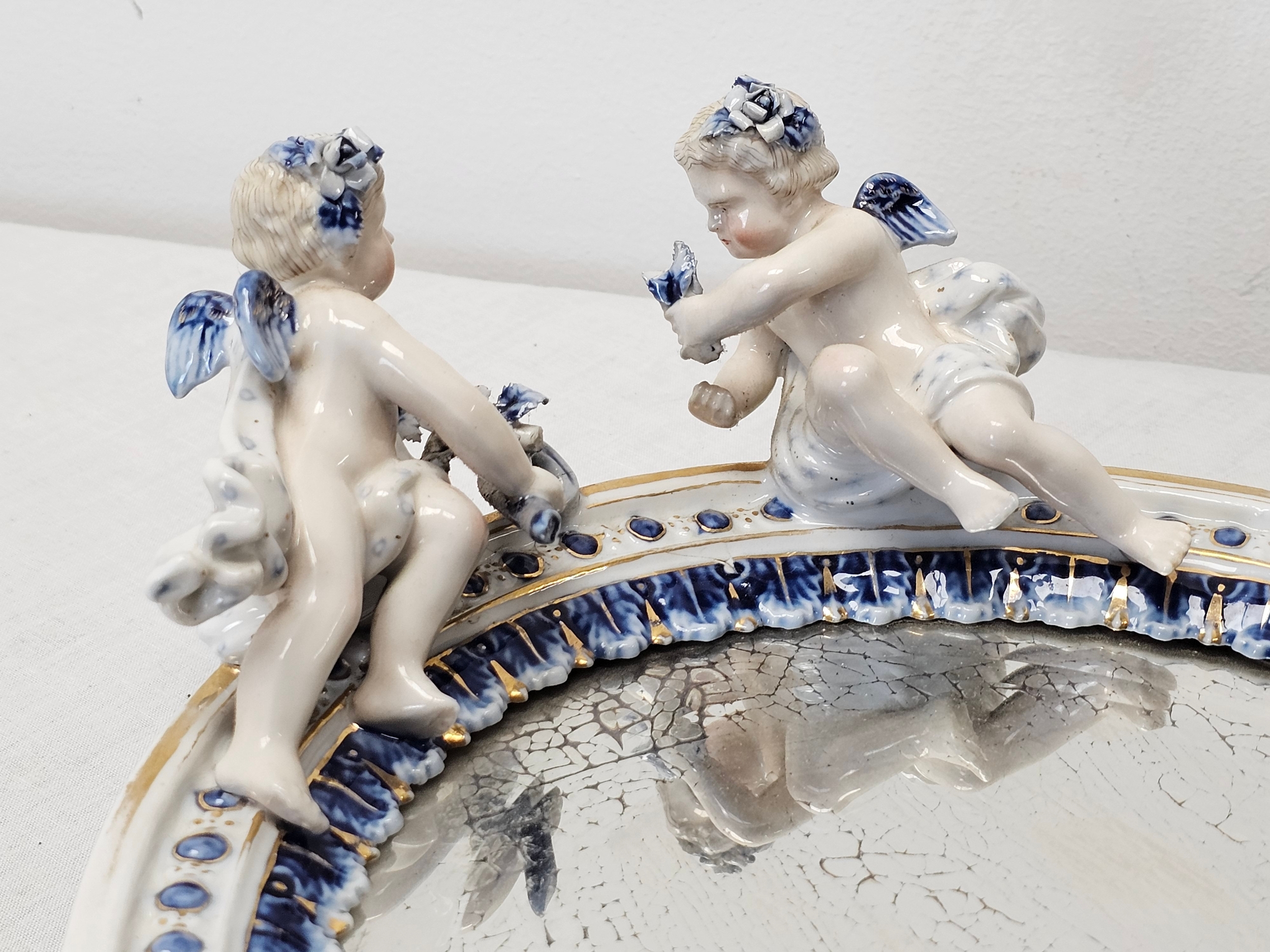 An early 20th century Sitzendorf hand painted relief cherub mirror with sculpted flower detailing. - Image 3 of 4