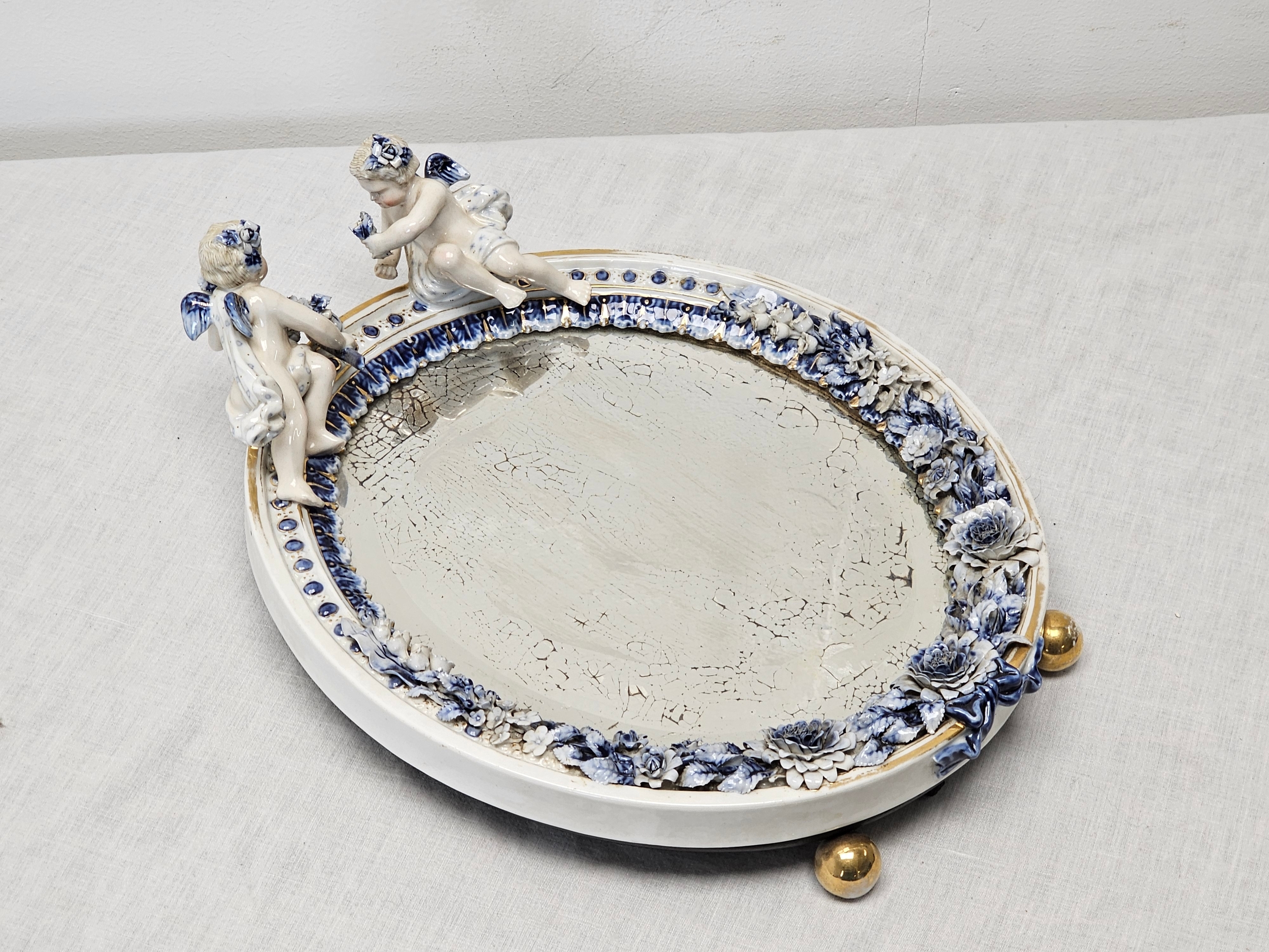 An early 20th century Sitzendorf hand painted relief cherub mirror with sculpted flower detailing. - Image 2 of 4