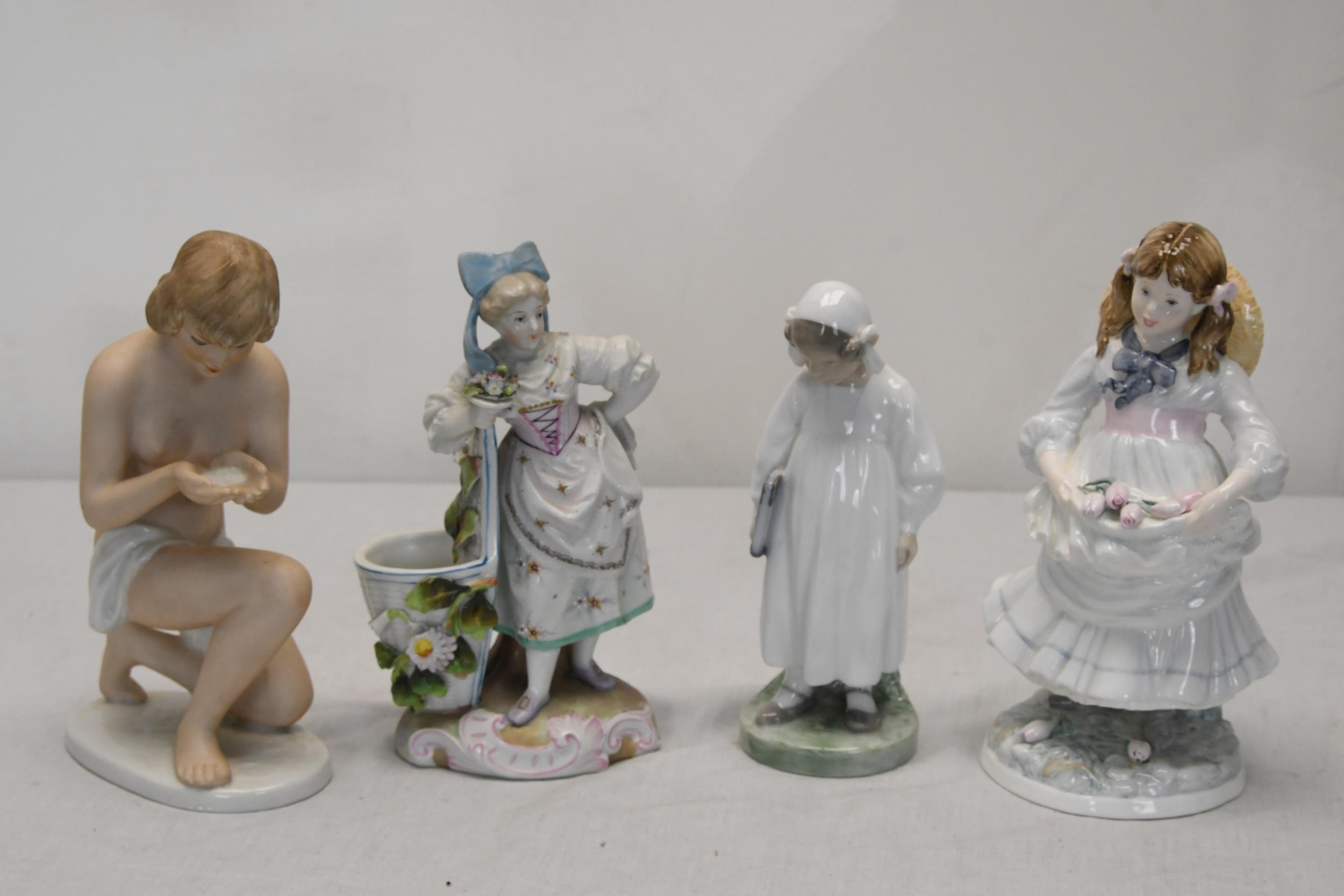 Four ceramic figures including Royal Copenhagen and Coalport.