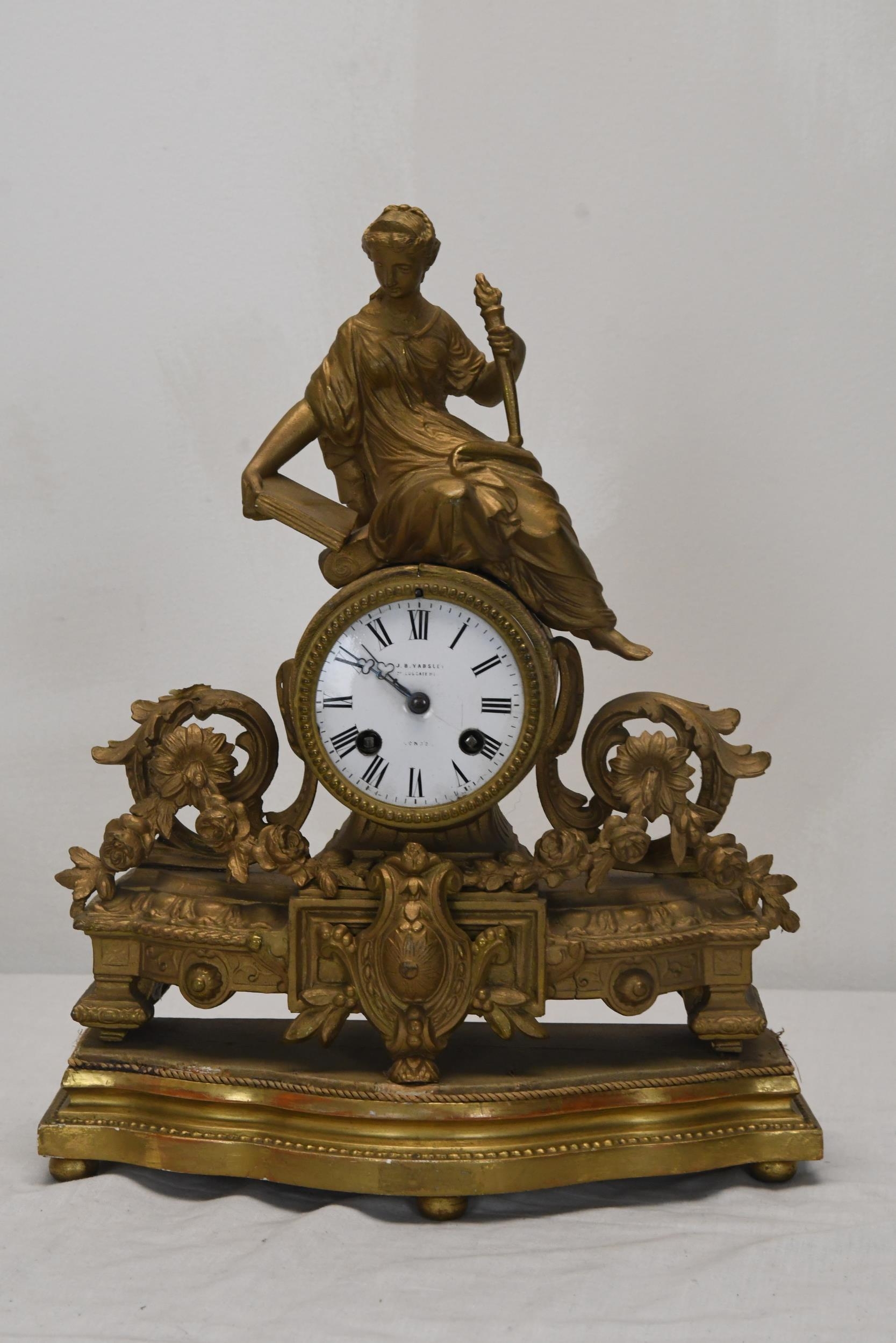 A French gilt metal figural clock with white enamelled dial. H.38 W.28 D.10