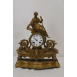 A French gilt metal figural clock with white enamelled dial. H.38 W.28 D.10