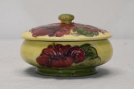 A Moorcroft Hibiscus lidded pot. H.8 W.12 D.12