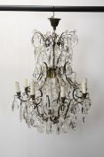 A Swedish crystal lead Chandelier, scrolling metal frame with eight branches and crystal drops.