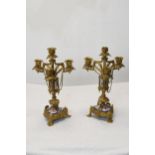 A pair of early 20th century Gothic style gilt metal four branch candelabras with hand painted