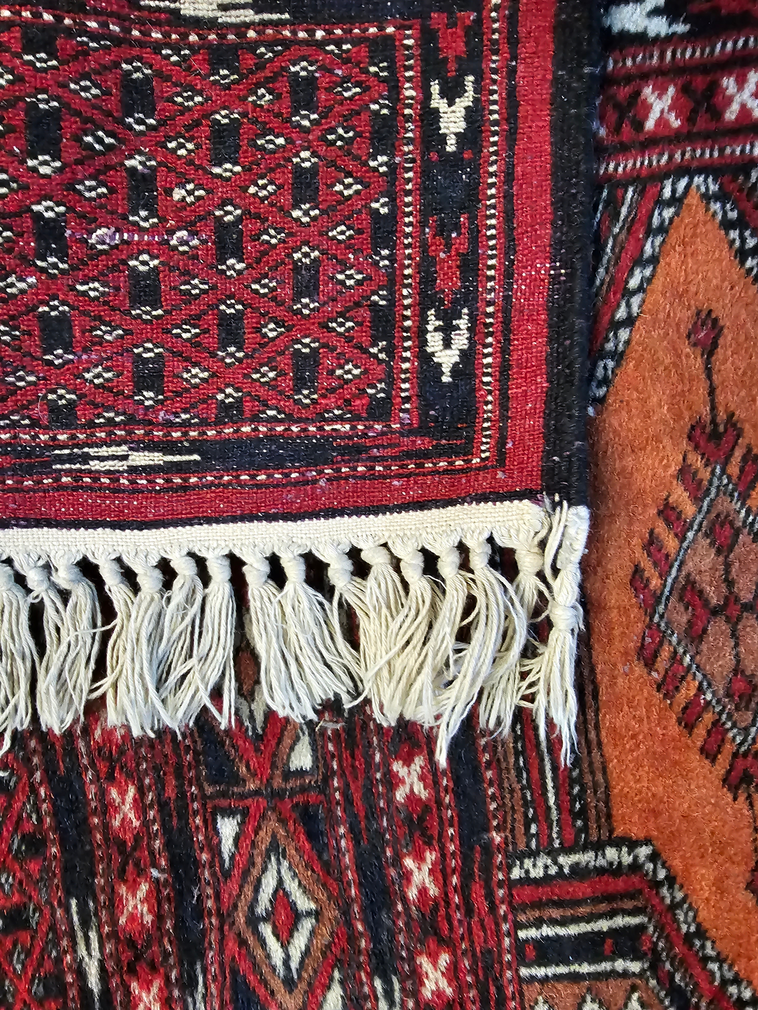A small Eastern rug with repeating lozenge medallions on a madder field within multiple geometric - Image 3 of 3