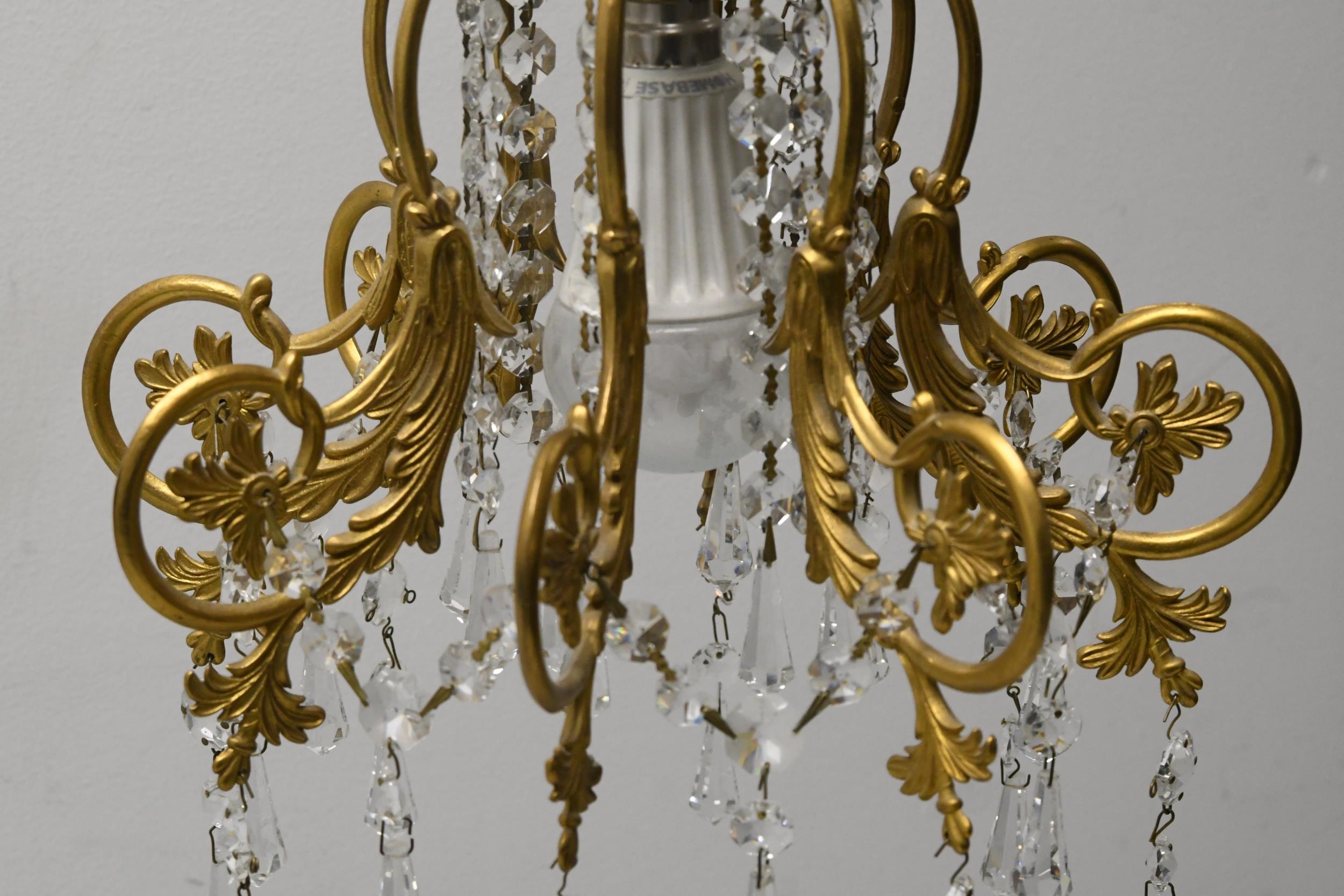 A pair of hanging ceiling lights with scrolling gilt metal frames and crystal drops. H.62 W.30 - Image 3 of 3
