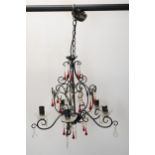 A wrought iron chandelier with five scrolling branches and ruby and cut crystal drops. H.70 W.45