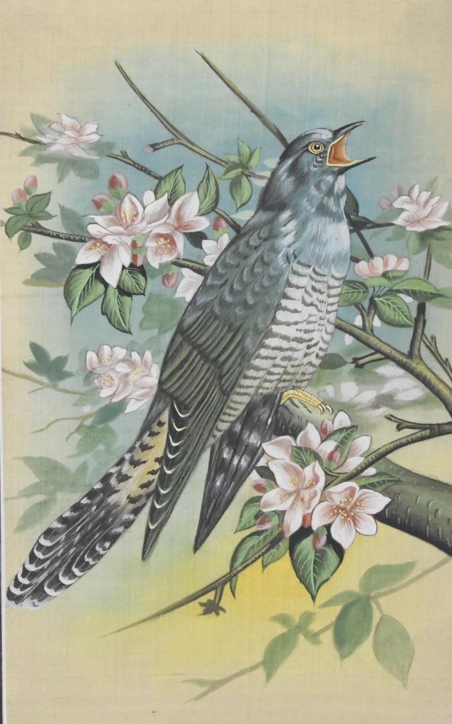 A framed and glazed painting on fabric of a cuckoo in the blossom tree, unsigned. H.36 W.26