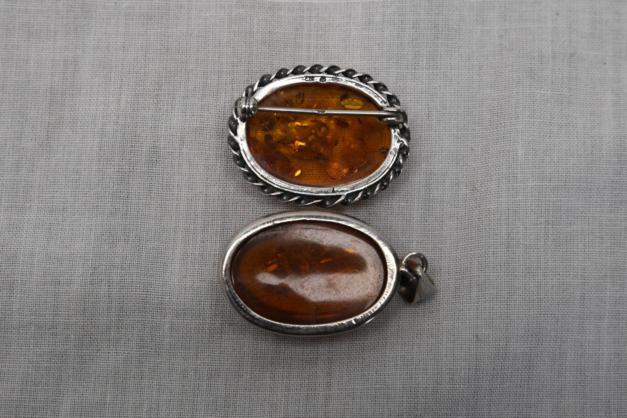 A silver and amber brooch and pendant. Size is H.4 W.2 D.1 - Image 2 of 2