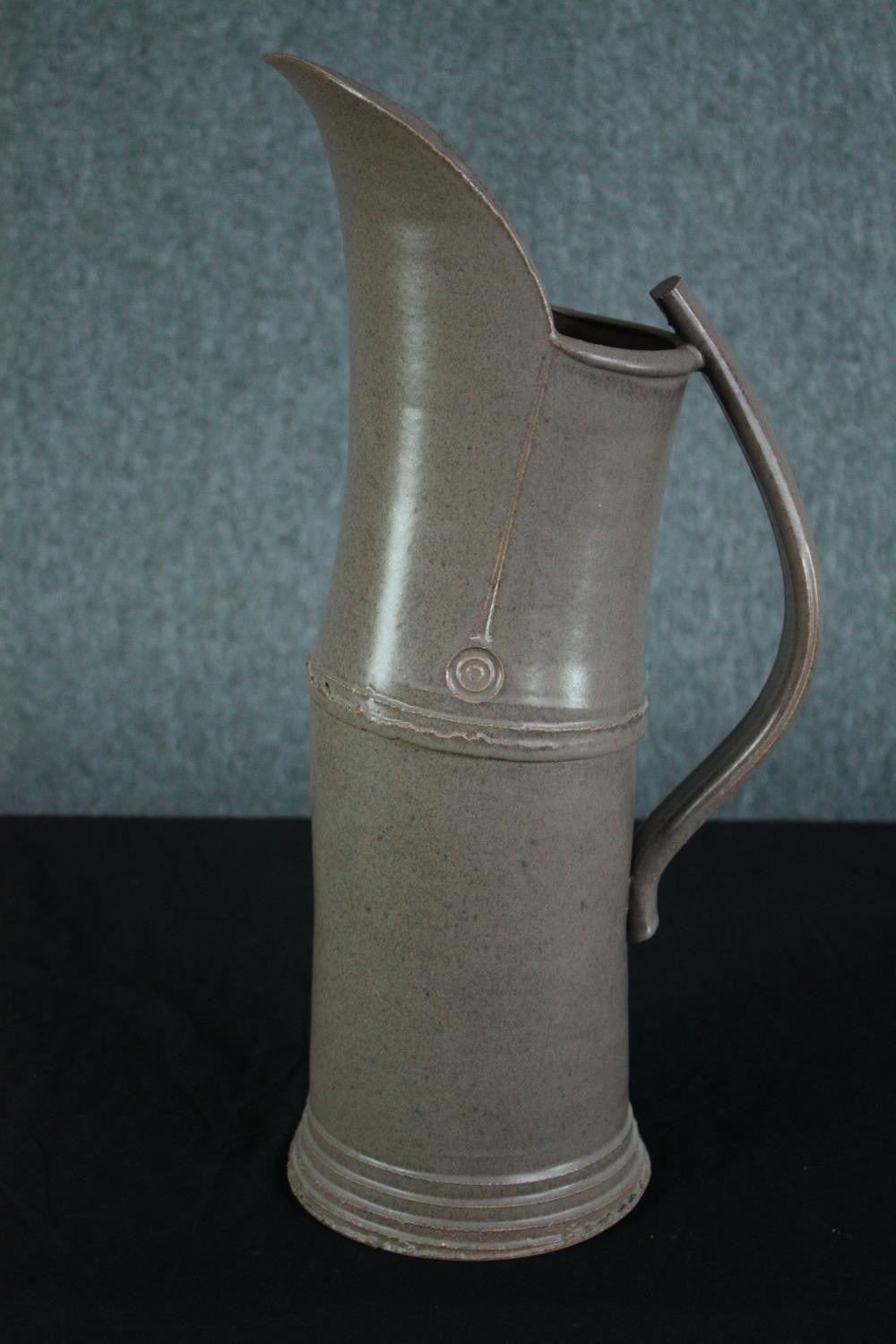 Walter Keeler, British, 1942-, a tall 'Articulated' salt-glaze stoneware jug, with applied strap