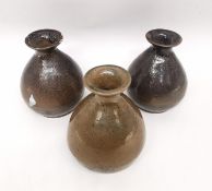 Three 20th century Japanese brown glaze bottle vases with raised character mark to the base. H.15cm