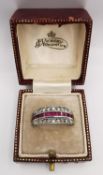 A boxed 9ct white gold Art Deco ruby and sapphire day night swivel eternity ring. Set with