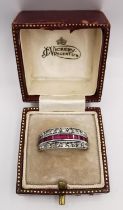 A boxed 9ct white gold Art Deco ruby and sapphire day night swivel eternity ring. Set with