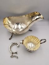 An Edwardian sterling silver sauce boat by Joseph Rodgers & Sons (handle broken) along with a