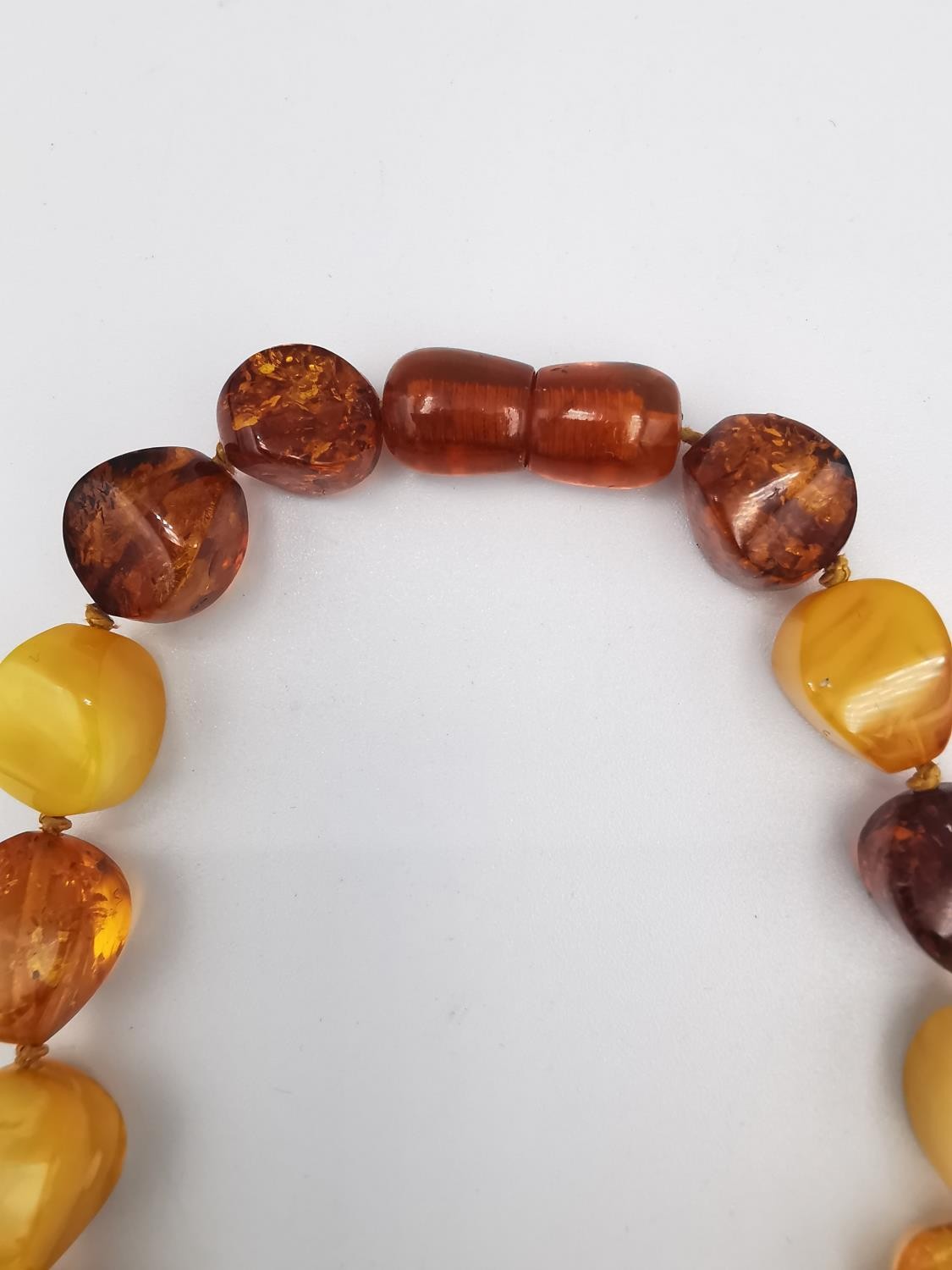 A collection of amber jewellery, including a long Baltic and butterscotch amber bead necklace with - Image 4 of 7