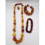 A collection of amber jewellery, including a long Baltic and butterscotch amber bead necklace with