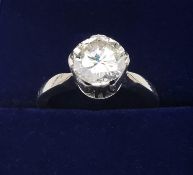 A boxed vintage white metal (tests as 14ct white gold) diamond solitaire ring, set with a round