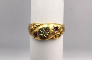 An antique 18ct yellow gold ruby and old mine diamond carved gypsy ring. Set with a round old mine