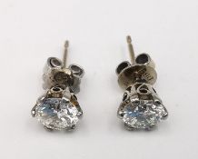 A pair of vintage 14ct white gold and diamond stud earrings, each earring set with a round brilliant
