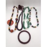 A collection of gemstone jewellery, including a garnet bead rope necklace and bangle, a green