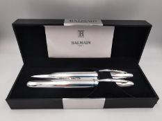A collection of designer pens, including a boxed Balmain chrome twin ballpoint pen set, a Pierre