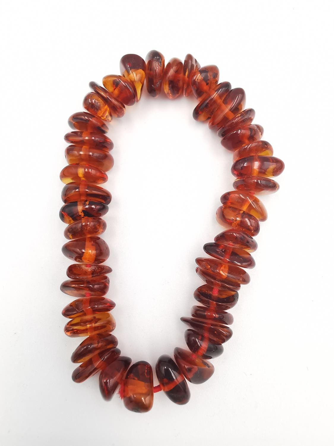 A collection of amber jewellery, including a long Baltic and butterscotch amber bead necklace with - Image 7 of 7