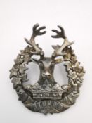 A Scottish Gordon Highland 1918 HM white metal (tests as silver) WWI officer Glengarry badge, with a