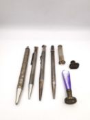 A collection of sterling silver ballpoint pens and pencils, seals and a silver cigar piercer. One