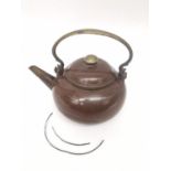 A Qing period Chinese polished Yixing clay teapot of rounded form with a brass scroll handle, the