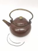 A Qing period Chinese polished Yixing clay teapot of rounded form with a brass scroll handle, the