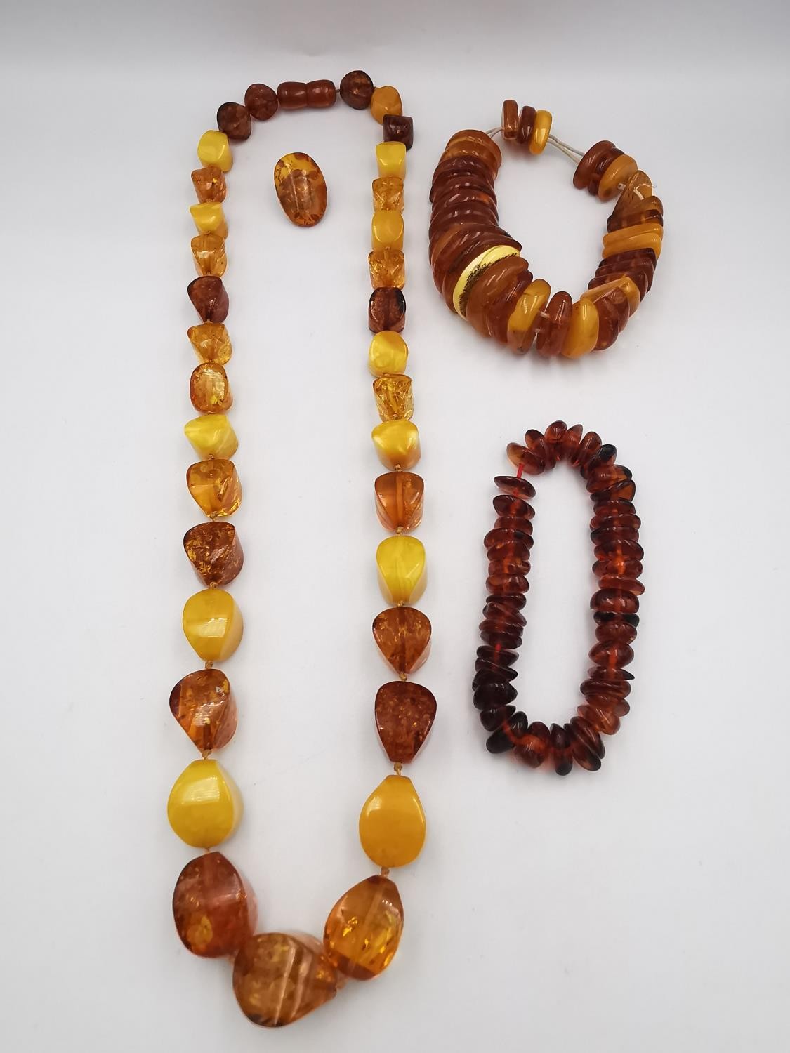 A collection of amber jewellery, including a long Baltic and butterscotch amber bead necklace with - Image 2 of 7