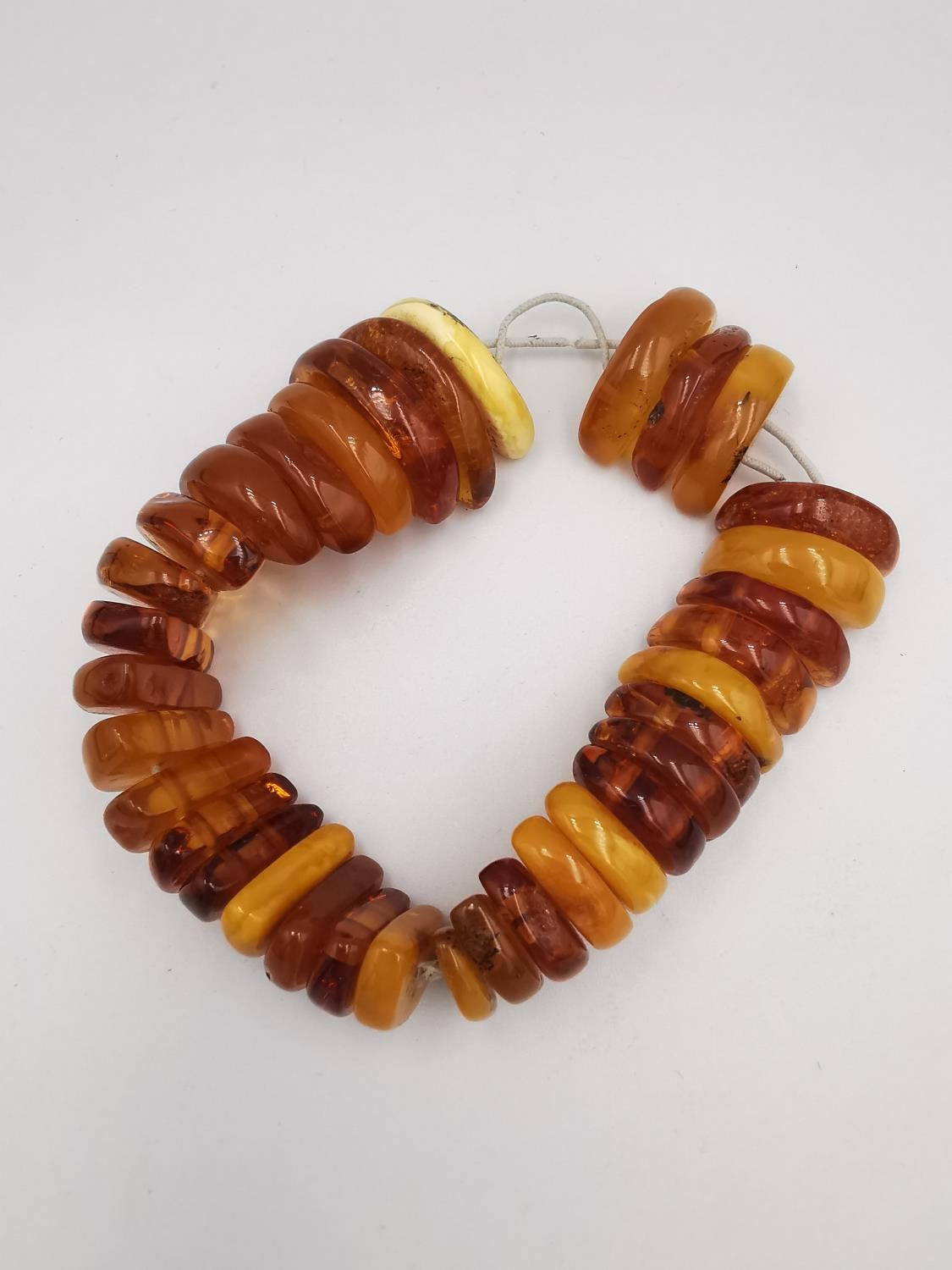 A collection of amber jewellery, including a long Baltic and butterscotch amber bead necklace with - Image 5 of 7