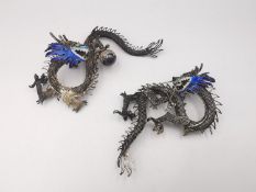 Two mid 20th century Chinese enamel and white metal filigree wirework dragons. Decorated with pale
