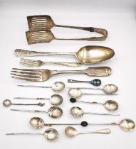 A collection of white metal and silver cutlery, including a pair of silver asparagus tongs, a
