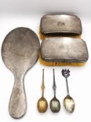 A collection of silver items, including an engine decorated brush set and hammered silver hand