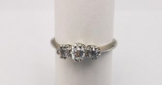 A boxed diamond platinum and 18ct white gold three stone ring. Set with three round old cut diamonds