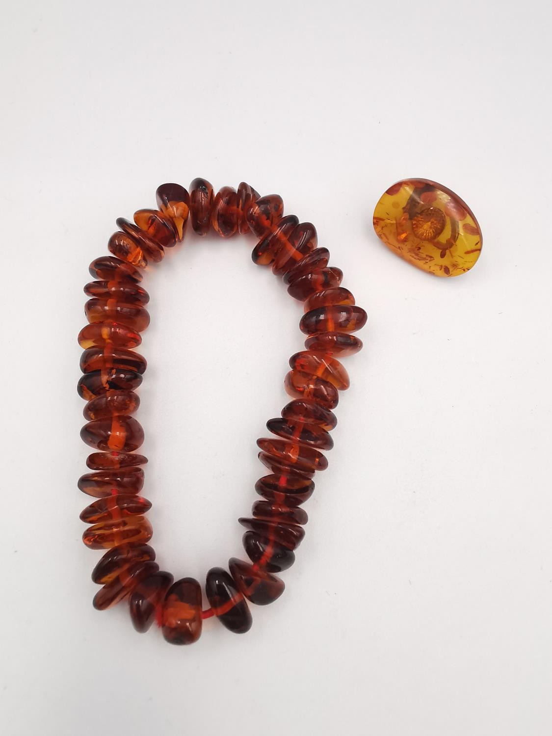 A collection of amber jewellery, including a long Baltic and butterscotch amber bead necklace with - Image 6 of 7