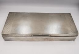 An Art Deco silver cedar lined cigarette box with three partitions. The lid with engine turned