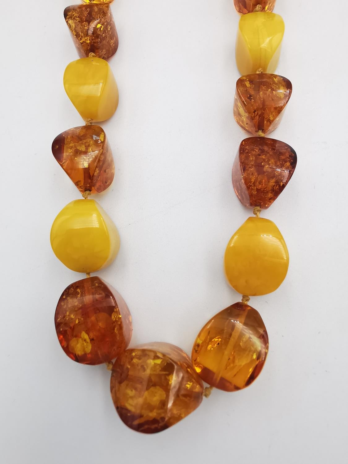 A collection of amber jewellery, including a long Baltic and butterscotch amber bead necklace with - Image 3 of 7